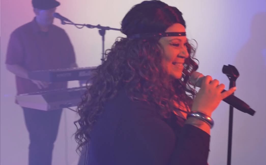 Christine B. performing with a microphone